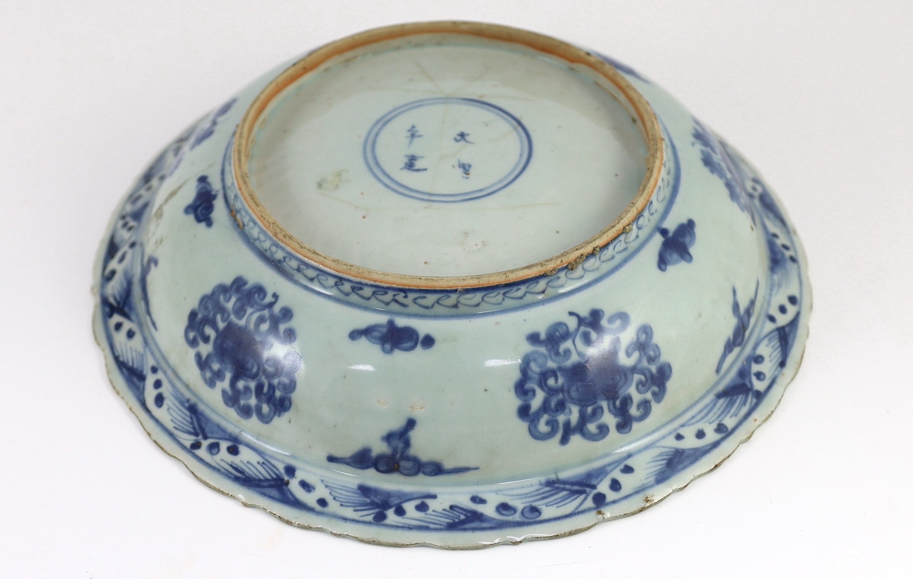 A Chinese Ming blue and white ‘lion’ dish, four character Ming mark, 31cm diameter, chip and cracks